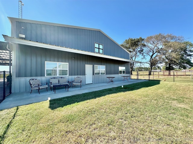 rear view of property with a yard and a patio