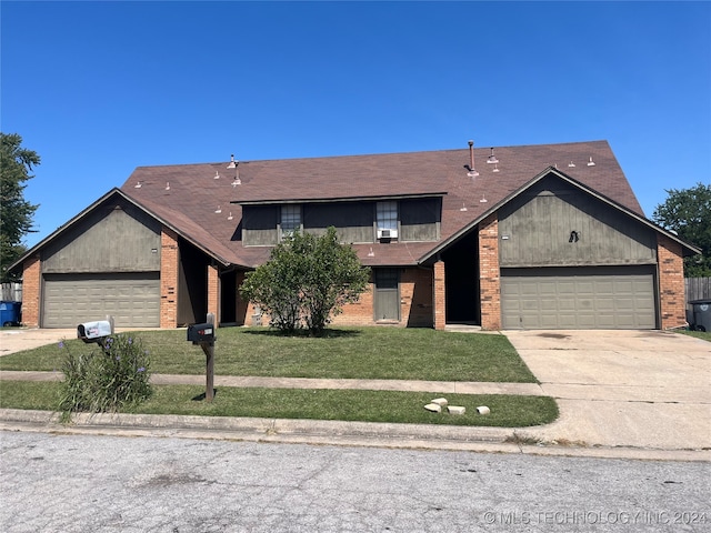 view of front of property with a front lawn and a garage