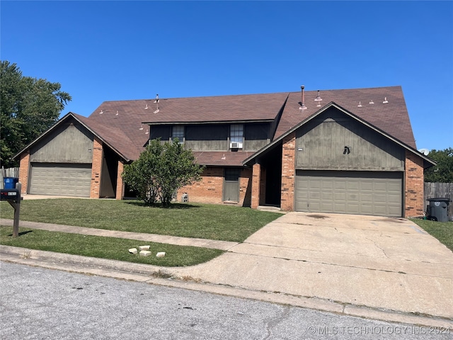 view of front of property with a front yard and a garage