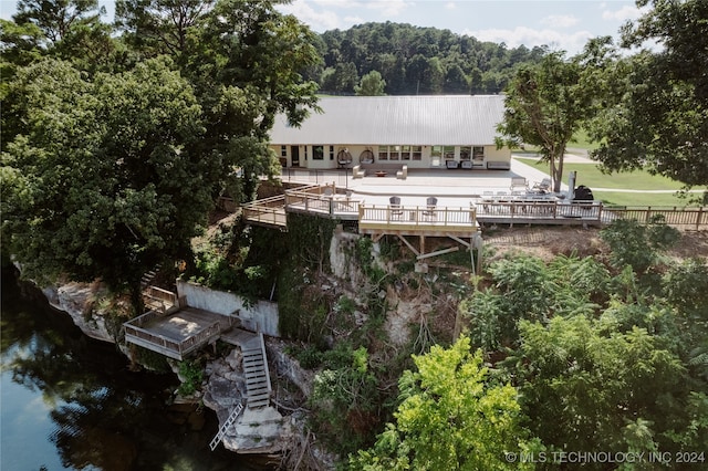 back of house featuring a patio and a water view