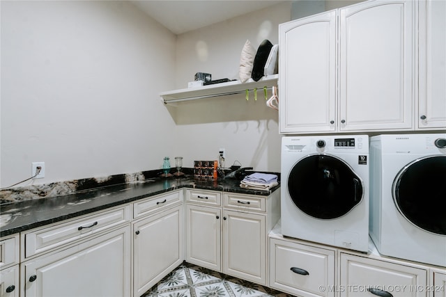 laundry room featuring washing machine and dryer and cabinets