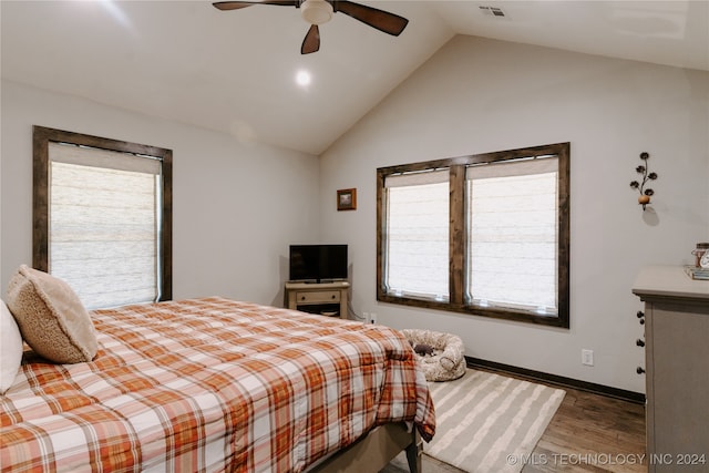 bedroom featuring ceiling fan, hardwood / wood-style flooring, and vaulted ceiling