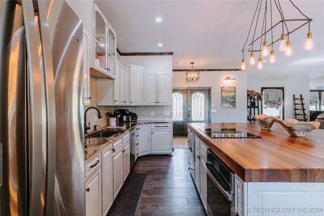 kitchen with white cabinets, sink, wooden counters, dark wood-type flooring, and stainless steel appliances