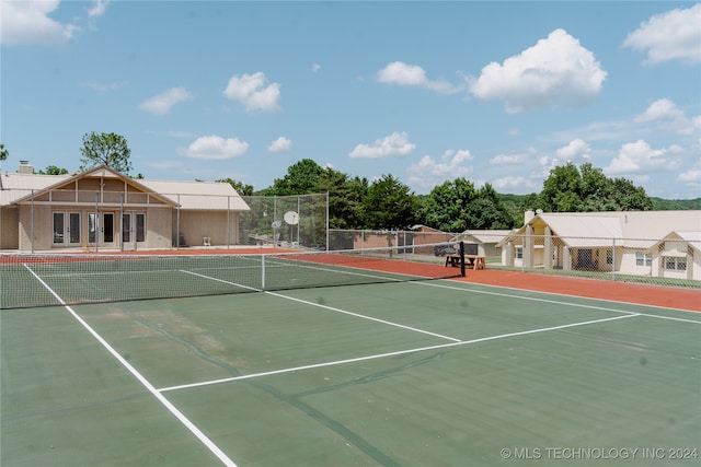 view of tennis court featuring basketball hoop