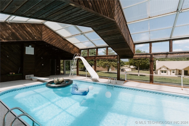 view of swimming pool with a diving board and a water slide