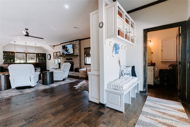 interior space with ornamental molding, lofted ceiling, and dark wood-type flooring