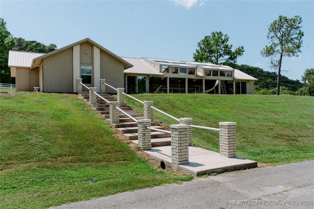 4100 N 430th Rd, Locust Grove, OK 74352 - mid-century home with a front yard, metal roof, brick siding, and stairway