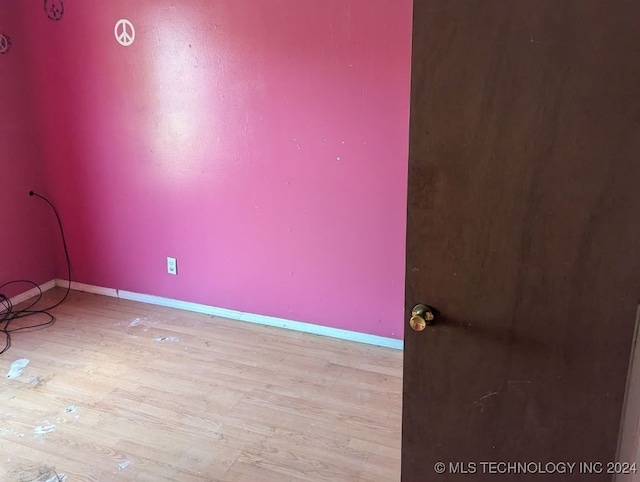 unfurnished room with light wood-type flooring