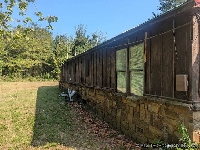 view of side of home featuring a lawn