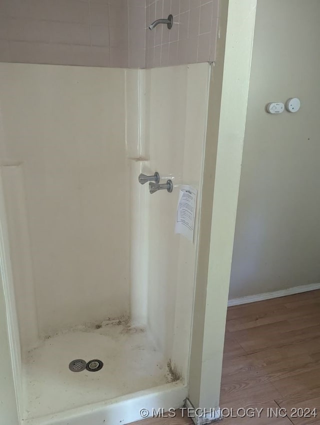 bathroom featuring a shower and hardwood / wood-style floors