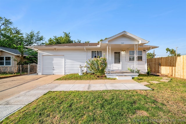 ranch-style house featuring a garage and a front lawn