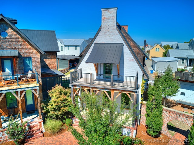 back of property featuring a balcony