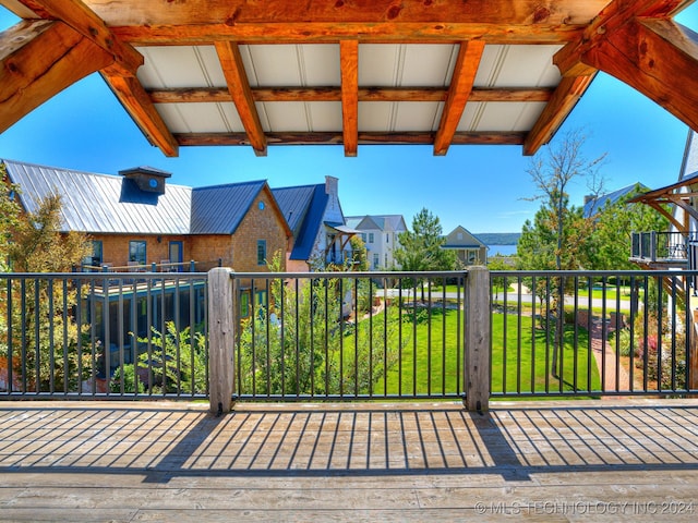 wooden deck with a lawn