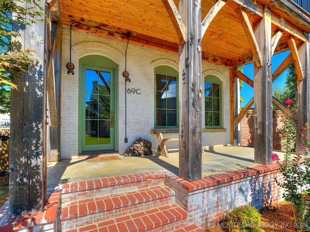 view of exterior entry with a porch