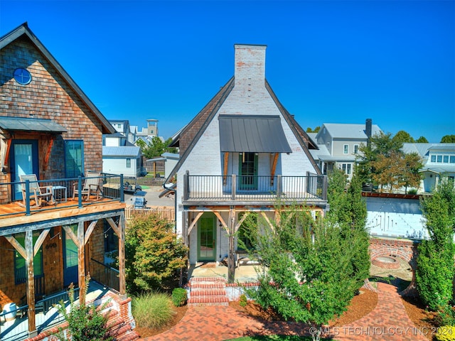 back of property with a balcony