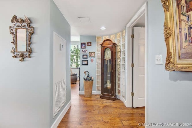 hall with hardwood / wood-style floors