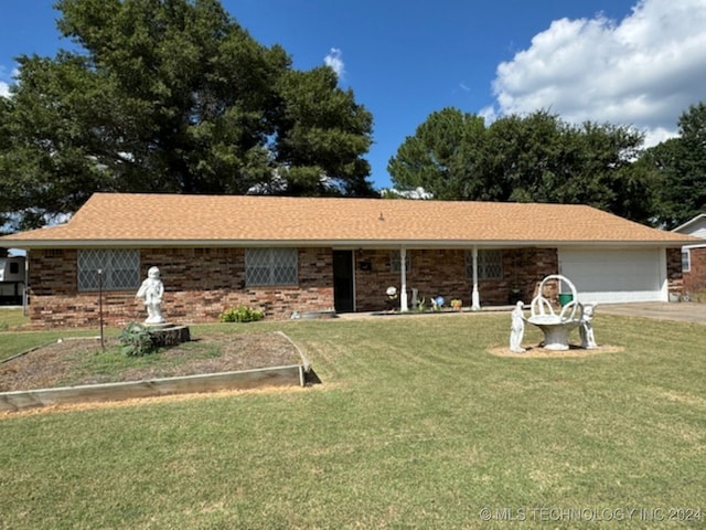 ranch-style home with a garage and a front yard