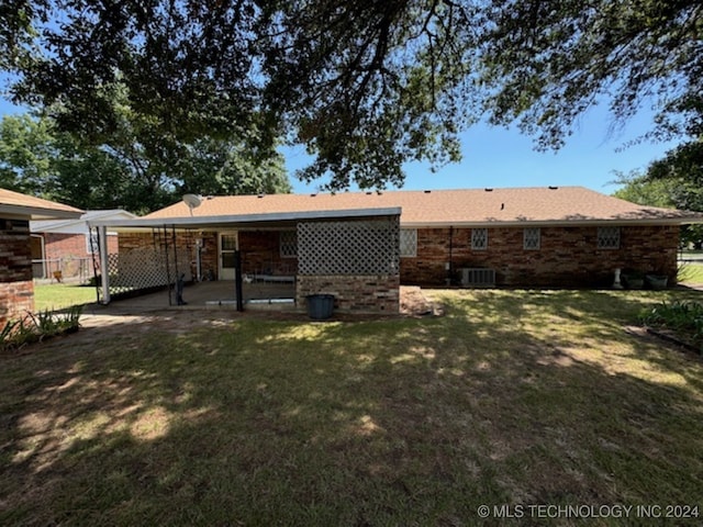 rear view of house featuring a yard, central AC, and a patio