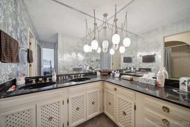 kitchen featuring a notable chandelier, cream cabinetry, and sink