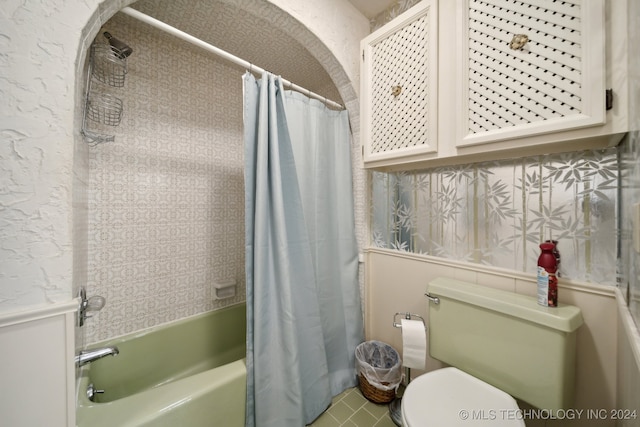 bathroom with shower / bath combination with curtain and toilet