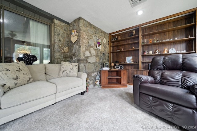 living room featuring a textured ceiling, vaulted ceiling, and light colored carpet