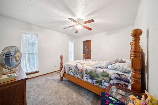 bedroom with ceiling fan, a textured ceiling, and carpet flooring