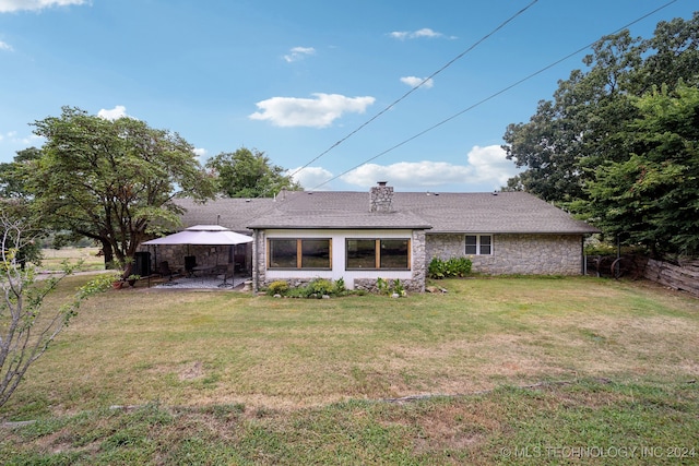 rear view of house with a lawn