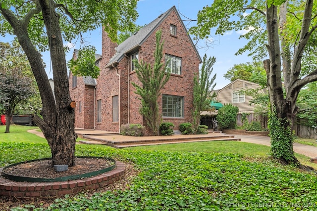 tudor house featuring a front lawn