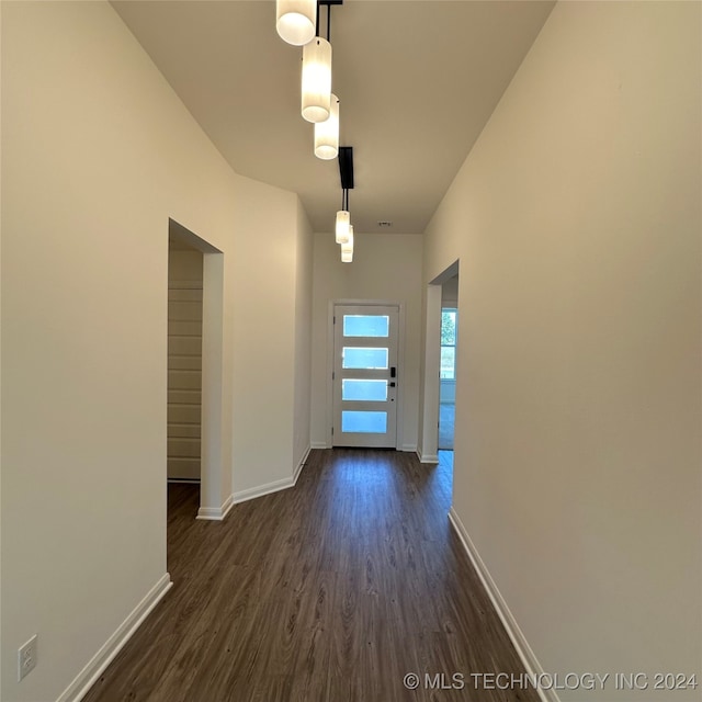 hallway with dark hardwood / wood-style flooring