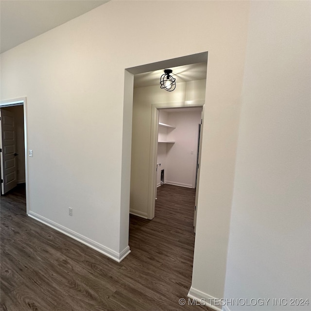 corridor with dark hardwood / wood-style floors