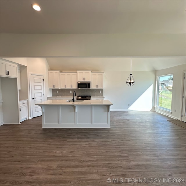 kitchen featuring decorative light fixtures, stainless steel appliances, sink, and dark hardwood / wood-style flooring