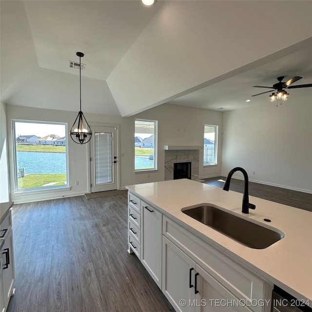 kitchen featuring sink, dark hardwood / wood-style flooring, decorative light fixtures, and white cabinets