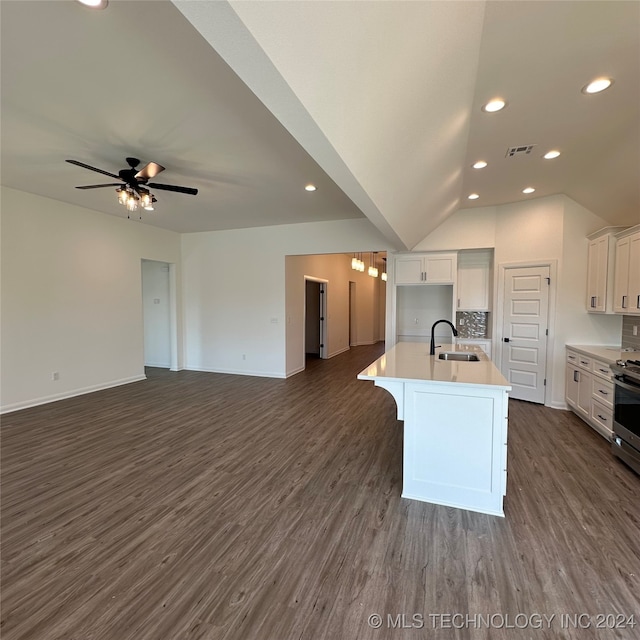 kitchen with a kitchen island with sink, dark hardwood / wood-style floors, sink, vaulted ceiling, and white cabinets