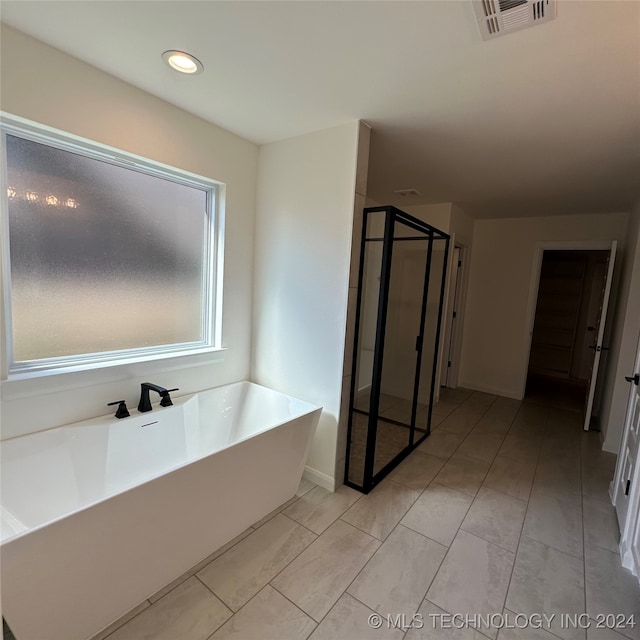 bathroom featuring separate shower and tub