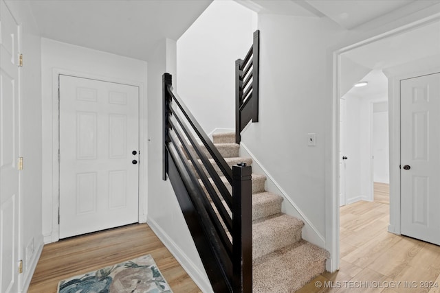 stairway featuring wood-type flooring