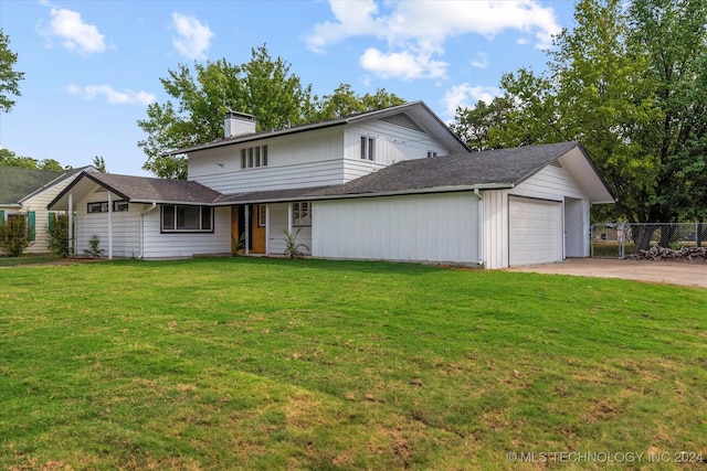 front facade with a garage and a front lawn