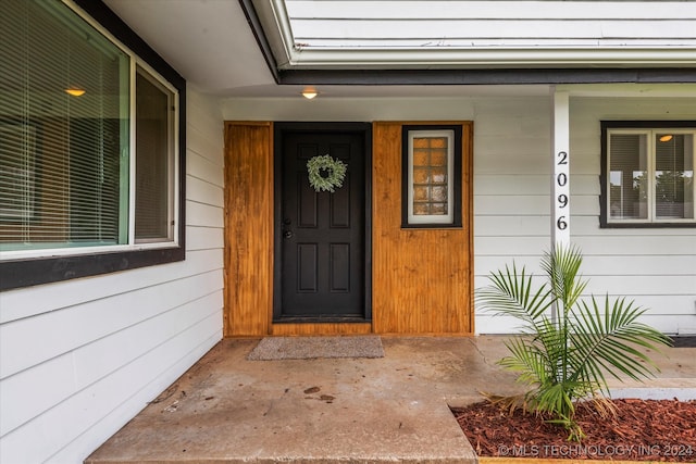 view of exterior entry featuring a porch