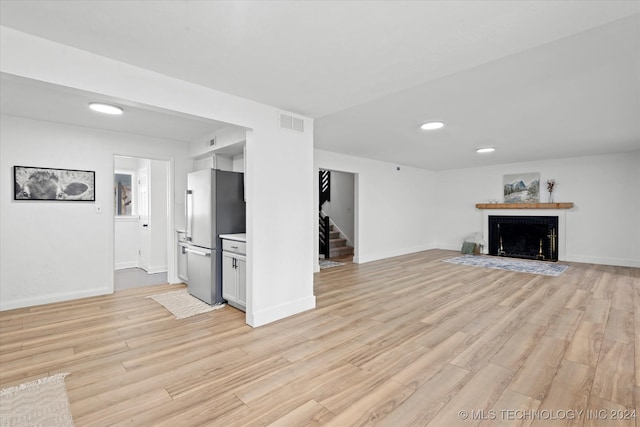 unfurnished living room with light wood-type flooring