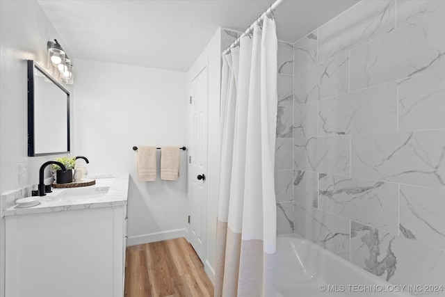 bathroom featuring vanity, shower / bath combo with shower curtain, and hardwood / wood-style floors