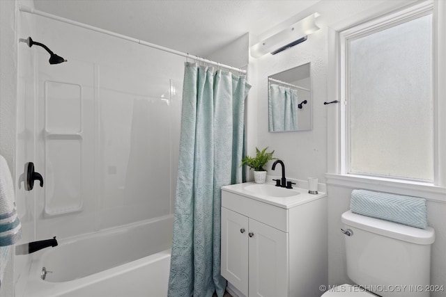 full bathroom with a textured ceiling, vanity, toilet, and shower / bath combo with shower curtain