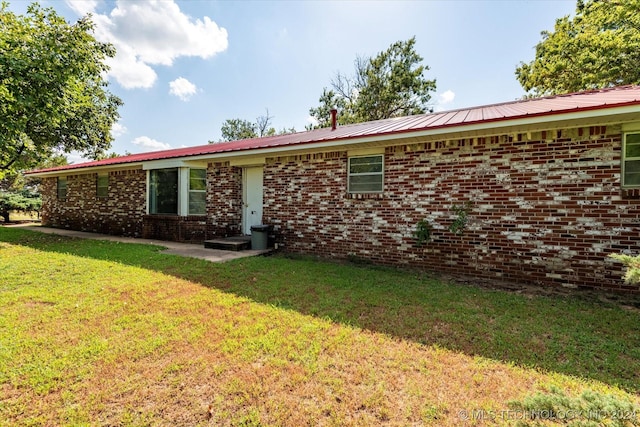 397956 W 3800, Ramona, OK 74061 - back of house featuring a lawn, brick siding, and metal roof