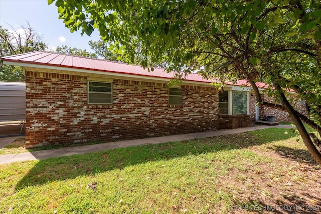 397956 W 3800, Ramona, OK 74061 - view of property exterior with brick siding, a yard, and metal roof