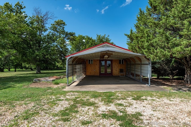 exterior space featuring a carport, a lawn, and french doors