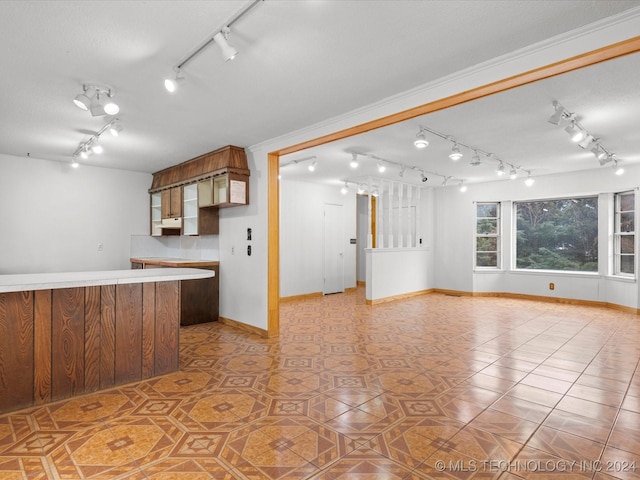 kitchen with light tile patterned floors and ornamental molding