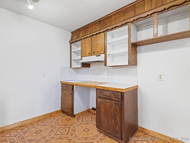 kitchen featuring decorative backsplash and a textured ceiling