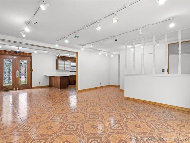 empty room featuring french doors and tile patterned floors