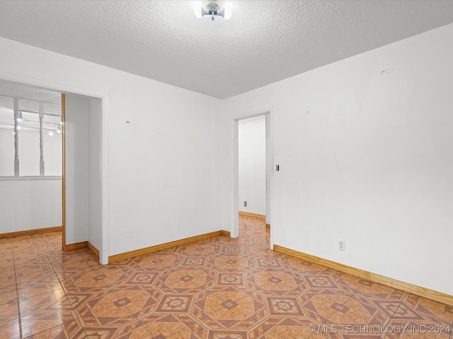 empty room featuring a textured ceiling