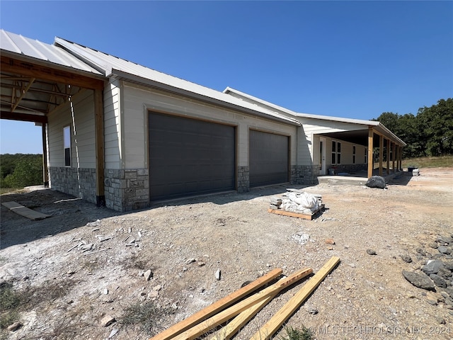 view of property exterior featuring an outbuilding and a garage