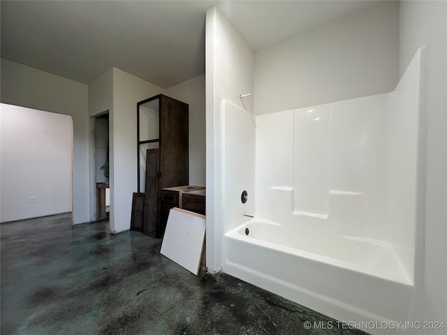 bathroom with shower / tub combination and concrete flooring