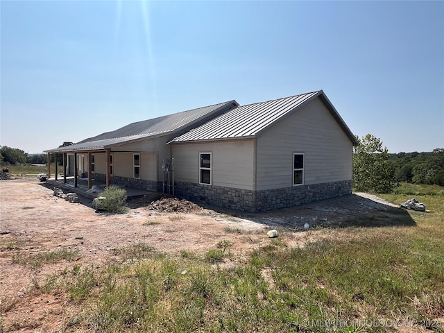 view of side of property with a patio area